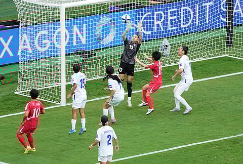 Uzbekistan's goalkeeper Zarina Saidova reaches up to take the ball during the Women's Asia Cup soccer match between North Korea and Uzbekistan in Sydney.