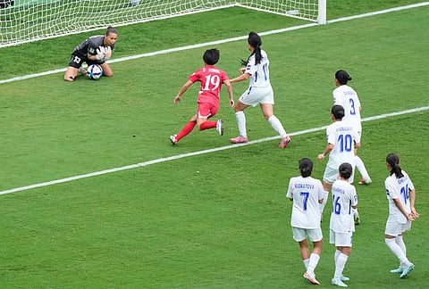 Uzbekistan's goalkeeper Zarina Saidova stops a free kick during the Women's Asia Cup soccer match between North Korea and Uzbekistan in Sydney.