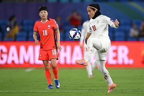 Iran's Sara Didar attempts to control the ball during the Women's Asia Cup soccer match between Iran and South Korea on the Gold Coast, Australia.