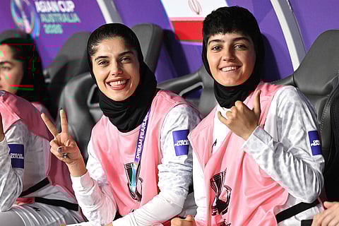 Iranian players gesture from the bench during the Women's Asia Cup soccer match between Iran and South Korea on the Gold Coast, Australia.