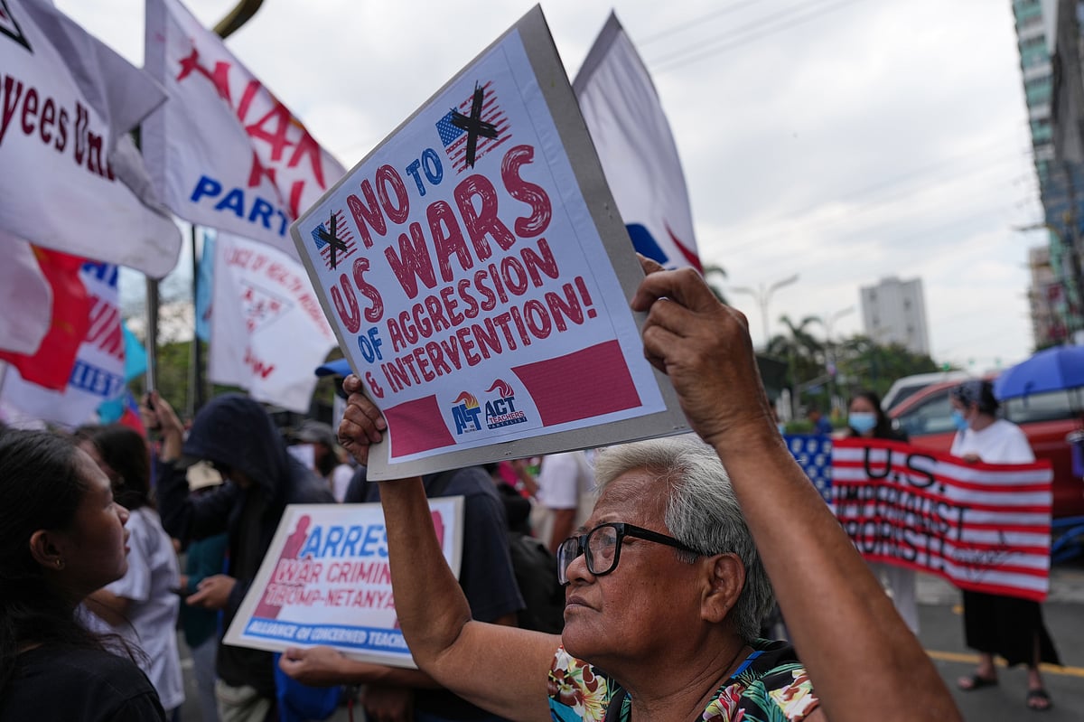 Protesters hold slogans during a rally in solidarity with Iran after they were blocked by police as they marched towards the U.S. embassy in Manila, Philippines on Tuesday, March 3, 2026. - AP