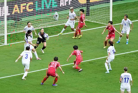 Uzbekistan's goalkeeper Zarina Saidova reaches for the ball during the Women's Asia Cup soccer match between North Korea and Uzbekistan in Sydney.
