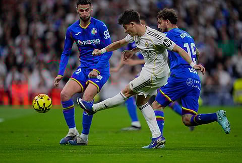 Real Madrid's Arda Guler kicks the ball during a Spanish La Liga soccer match between Real Madrid and Getafe in Madrid, Spain.