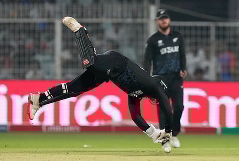 New Zealand's Tim Seifert dives to field the ball during the first T20 World Cup cricket semifinal match between New Zealand and South Africa in Kolkata.