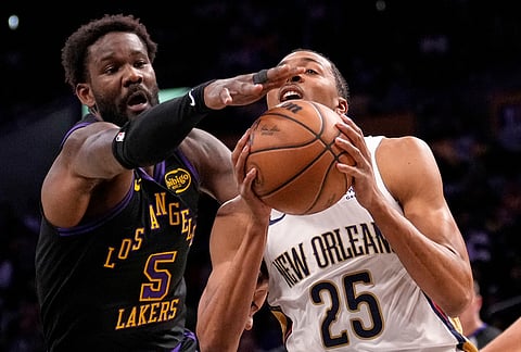 New Orleans Pelicans forward Trey Murphy III, right, goes up for a shot as Los Angeles Lakers center Deandre Ayton defends during the first half of an NBA basketball game in Los Angeles.