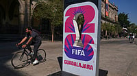 AP : A cyclist rides past an installation promoting the FIFA World Cup 2026 in Guadalajara, Mexico.