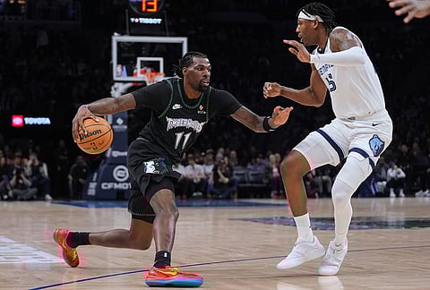Minnesota Timberwolves center Naz Reid (11) works toward the basket as Memphis Grizzlies forward GG Jackson defends during the first half of an NBA basketball game, in Minneapolis. 