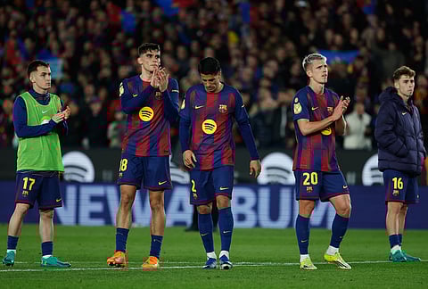 Barcelona's Marc Casado, from left, Gerard Martin, Joao Cancelo, Dani Olmo and Fermin Lopez react after the Copa del Rey semifinal second leg soccer match between Barcelona and Atletico Madrid in Barcelona, Spain.