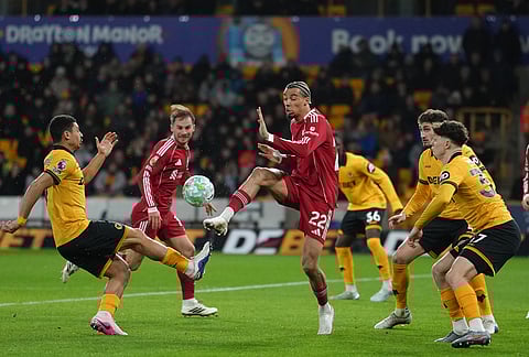 Liverpool's Hugo Ekitike, center, controls the ball during the English Premier League soccer match between Wolverhampton Wanderers and Liverpool in Wolverhampton, England.