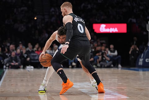 Memphis Grizzlies guard Ty Jerome (2) works toward the basket as Minnesota Timberwolves guard Donte DiVincenzo (0) defends during the second half of an NBA basketball game, in Minneapolis.