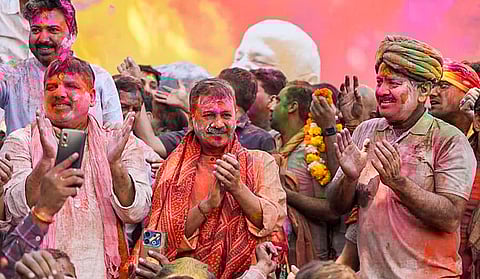 Aam Aadmi Party (AAP) chief Arvind Kejriwal and party leaders Sanjay Singh and Manish Sisodia celebrate the Holi festival at the latter's residence, in New Delhi. 