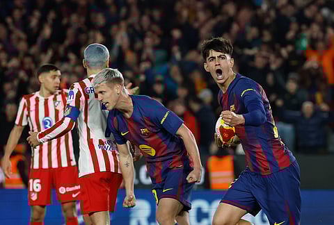 Barcelona's Marc Bernal celebrates after scoring his side's third goal during the Copa del Rey semifinal second leg soccer match between Barcelona and Atletico Madrid in Barcelona, Spain.