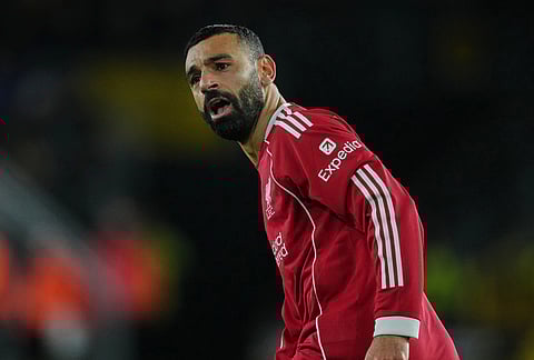 Liverpool's Mohamed Salah reacts during the English Premier League soccer match between Wolverhampton Wanderers and Liverpool in Wolverhampton, England.