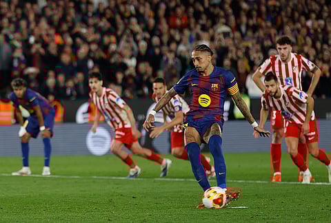 Barcelona's Raphinha scores from the penalty spot his side's second goal during the Copa del Rey semifinal second leg soccer match between Barcelona and Atletico Madrid in Barcelona, Spain.