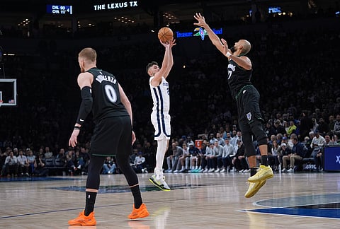 Memphis Grizzlies guard Ty Jerome (2), middle, shoots over Minnesota Timberwolves center Rudy Gobert (27), right, during the second half of an NBA basketball game, in Minneapolis.