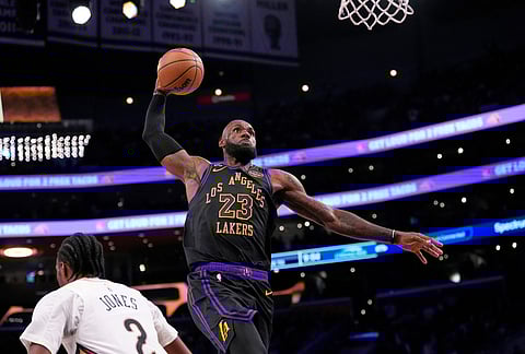 Los Angeles Lakers forward LeBron James, right, dunks as New Orleans Pelicans forward Herbert Jones defends during the second half of an NBA basketball game in Los Angeles.
