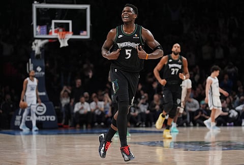 Minnesota Timberwolves guard Anthony Edwards (5) celebrates after making a 3-point shot during the second half of an NBA basketball game against the Memphis Grizzlies, in Minneapolis.
