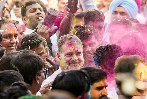 Congress leader and Leader of Opposition in the Lok Sabha Rahul Gandhi celebrate the Holi festival with others at the party office, in New Delhi.