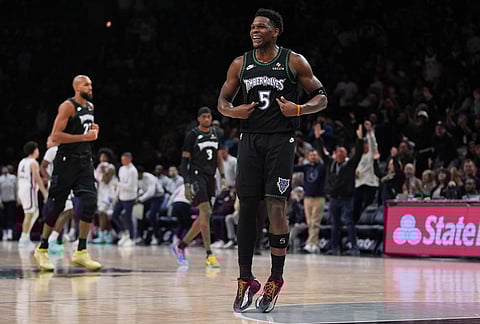 Minnesota Timberwolves guard Anthony Edwards (5) celebrates after making a 3-point shot during the second half of an NBA basketball game against the Memphis Grizzlies, in Minneapolis.
