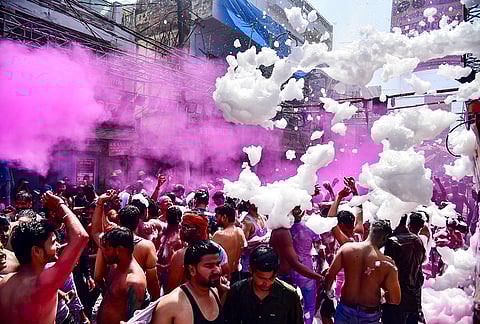 People celebrate the Holi festival, in Prayagraj, Uttar Pradesh.