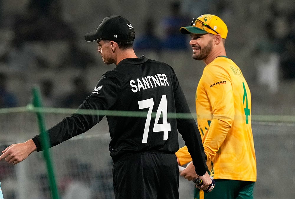 New Zealand's captain Mitchel Santner, left, and South Africa's captain Aiden Markram move for the coin toss of the first T20 World Cup cricket semifinal match between New Zealand and South Africa in Kolkata.
 -  Photo AP/Bikas Das