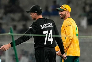 Photo AP/Bikas Das : New Zealand's captain Mitchel Santner, left, and South Africa's captain Aiden Markram move for the coin toss of the first T20 World Cup cricket semifinal match between New Zealand and South Africa in Kolkata.