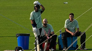 AP Photo/Bikas Das : New Zealand's captain Mitchel Santner, right, Daryl Mitchell, centre and Rachin Ravindra take a break during the practice session ahead of their T20 World Cup cricket match against South Africa, in Kolkata, India, Tuesday, March 3, 2026.