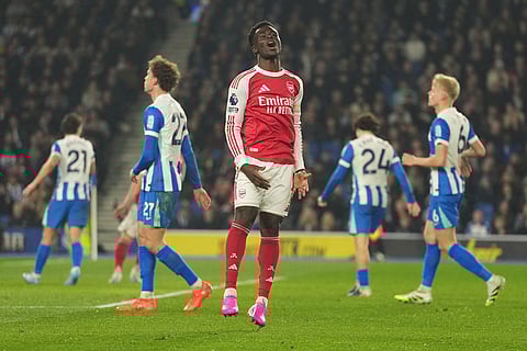 Arsenal's Bukayo Saka reacts during the Premier League soccer match between Brighton and Arsenal in Brighton, England.