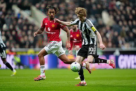 Manchester United's Leny Yoro, left, and Newcastle United's Anthony Gordon battle for the ball during their English Premier League soccer match in Newcastle, England.
