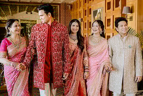 Cricketer Sachin Tendulkar, right, with wife Anjali Tendulkar, left, daughter Sara Tendulkar, second right, during his son's Arjun Tendulkar, second left, and industrialist Ravi Ghai’s granddaughter Saaniya Chandhok wedding ceremony, in Mumbai.