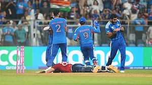 (AP Photo/Rafiq Maqbool) : England's Jacob Bethell lies on the ground as Indian players celebrate his run out during the T20 World Cup cricket semi-final match between India and England in Mumbai, India, Thursday, March 5, 2026