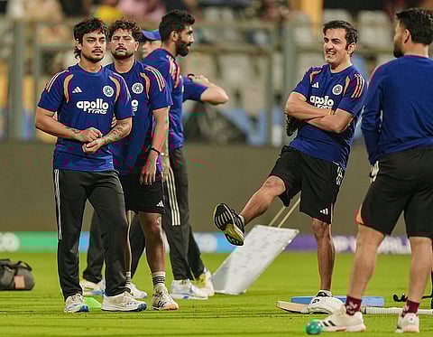 India's head coach Gautam Gambhir, second right, with Kuldeep Yadav, Ishan Kishan and others during a training session ahead of the ICC Men's T20 World Cup 2026 semi-final cricket match between India and England, in Mumbai.