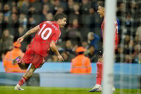 Nottingham Forest's Morgan Gibbs-White, left, celebrates after scoring his side's first goal during the English Premier League soccer match between Manchester City and Nottingham Forest in Manchester, England.