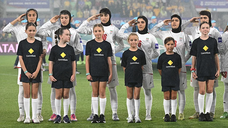 Iran players react during their national anthem ahead of the Women's Asia Cup soccer match between Australia and Iran in Robina, Australia, Thursday, March 5, 2026. - (Dave Hunt/AAPImage via AP)
