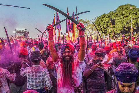 People take part in a Holla Mohalla Nagar Kirtan procession, in Hyderabad. Holla Mohalla, started by Guru Gobind Singh, features displays of martial traditions and community celebrations. 