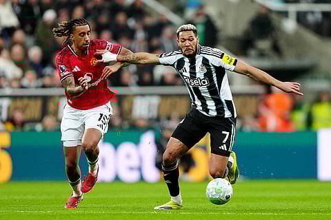 Manchester United's Leny Yoro, left, and Newcastle United's Joelinton in action during their English Premier League soccer match in Newcastle, England.