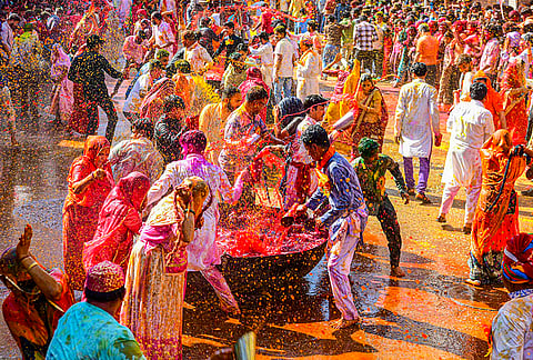 People splash coloured water and celebrate Holi during the traditional Kodamar Holi festivities, in Beawar, Rajasthan.
