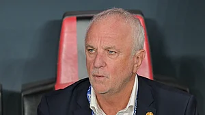 (AP Photo/Walid Ibrahim, File) : FILE- Iraqi's head coach Graham Arnold sits on the bench at the start of the 2026 World Cup play off first leg soccer match between UAE and Iraq in Abu Dhabi, United Arab Emirates, Friday, Nov. 14, 2025.