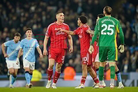 Manchester City's Gianluigi Donnarumma and Nottingham Forest's Nikola Milenkovic are kept apart after an altercation during the English Premier League soccer match between Manchester City and Nottingham Forest in Manchester, England.