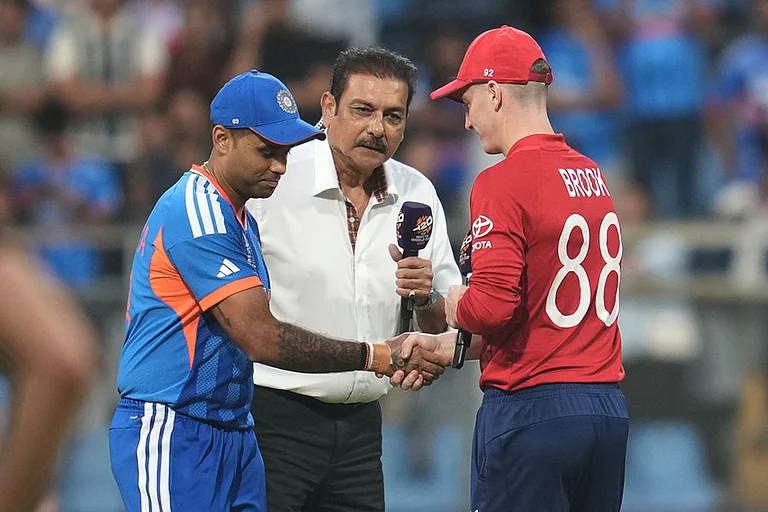 England's captain Harry Brook, right, and India's captain Suryakumar Yadav shake hands at the toss ahead of the T20 World Cup cricket semi-final match between India and England in Mumbai. - | Photo: AP/Rafiq Maqbool