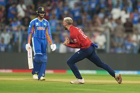 England's Will Jacks, right, celebrates the dismissal of India's Abhishek Sharma, left, during the T20 World Cup cricket semi-final match between India and England in Mumbai, India.