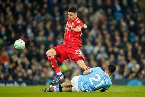 Nottingham Forest's Jair Cunha is challenged by Manchester City's Rayan Ait-Nouri during the English Premier League soccer match between Manchester City and Nottingham Forest in Manchester, England.