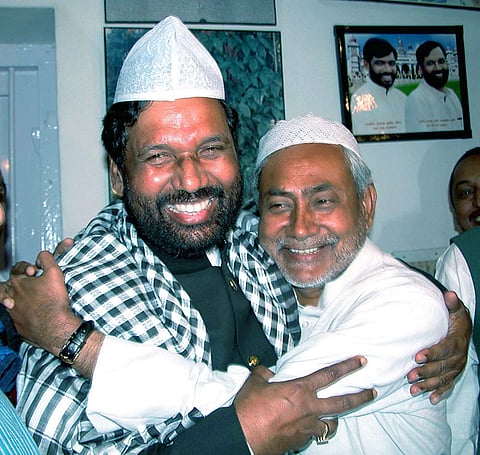 Union Minister and LJP chief Ram Vilas Paswan with JD(U) leader Nitish Kumar during an iftar party, in Patna, in this Nov. 8, 2004, file image. 