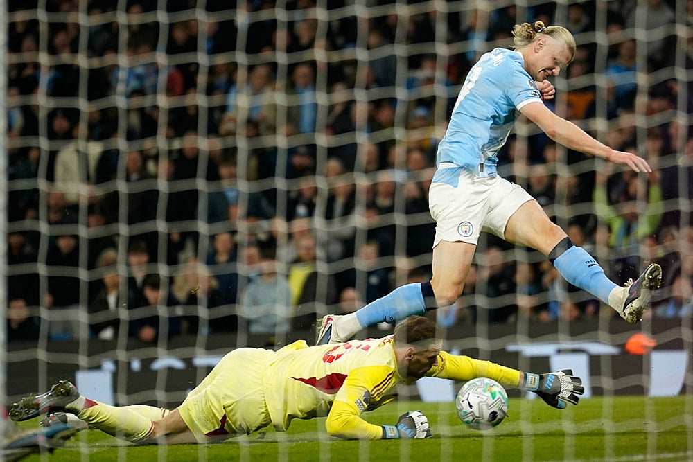 Nottingham Forest's goalkeeper Matz Sels saves at the feet of Manchester City's Erling Haaland during the English Premier League soccer match between Manchester City and Nottingham Forest in Manchester, England. - | Photo: AP/Dave Thompson