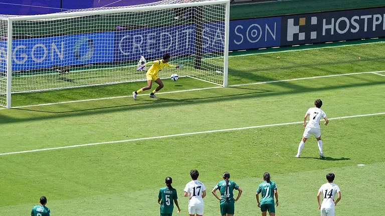 North Korea's Myong Yu Jong, right, scores against Bangladesh's goalkeeper Mile Akter from a penalty during their Women's Asian Cup match in Sydney, Friday, March 6, 2026. - | Photo: AP/Rick Rycroft