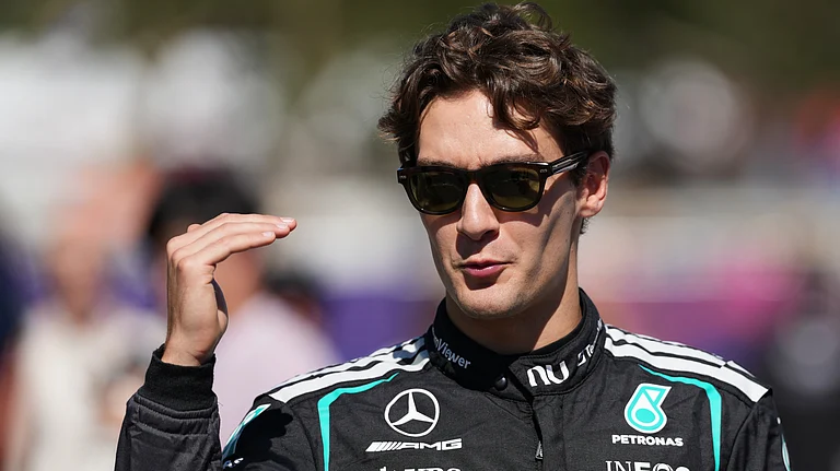 Mercedes driver George Russell of Britain gestures as he walks down the F1 Paddock ahead of the Australian Formula One Grand Prix at Albert Park, in Melbourne, Australia. - AP/Heath McKinley