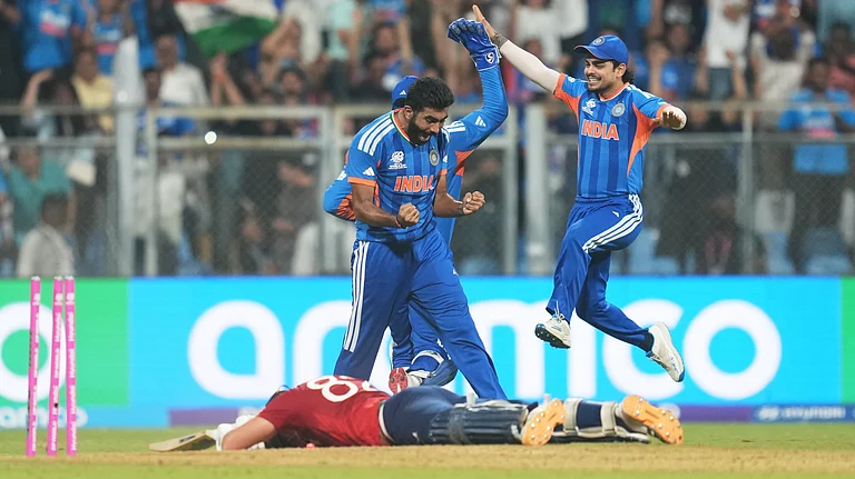 India's Jasprit Bumrah, left, and teammates celebrate the run out of England's Jacob Bethell, on ground, during the T20 World Cup cricket semi-final match between India and England in Mumbai, India, Thursday, March 5, 2026. - | Photo: AP/Rafiq Maqbool