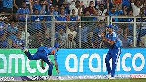 (AP Photo/Rafiq Maqbool) : India's Axar Patel, left, passes the ball to teammate Shivam Dube to dismiss England's Will Jacks during the T20 World Cup cricket semi-final match between India and England in Mumbai, India, Thursday, March 5, 2026.