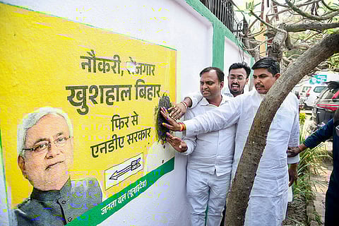 JD(U) workers smear black ink on a wall during a protest against the decision of Bihar Chief Minister Nitish Kumar to enter the Rajya Sabha, a move seen as signalling the end of his more than two-and-a-half-decade-long stint in state politics, in Patna.