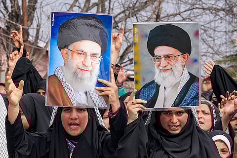 People hold portraits of Iran's supreme leader Ayatollah Ali Khamenei during a protest against the killing of Khamenei amid restrictions on the movement of people in the Kashmir valley, in Budgam, Jammu and Kashmir.
